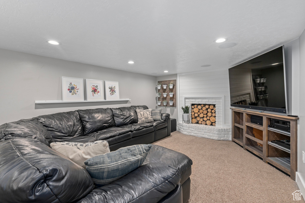 Living area with carpet floors, a fireplace, and recessed lighting