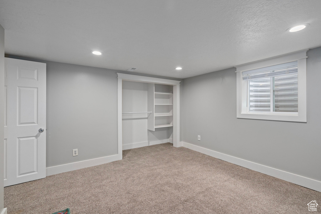 Unfurnished bedroom featuring carpet, baseboards, and recessed lighting