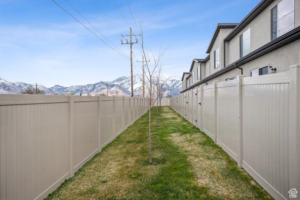 View of yard featuring a mountain view and a fenced backyard