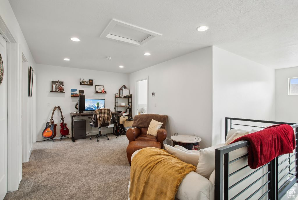 Living room featuring carpet floors, attic access, and recessed lighting