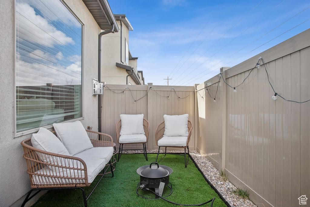 Exterior space featuring outdoor lounge area and fence