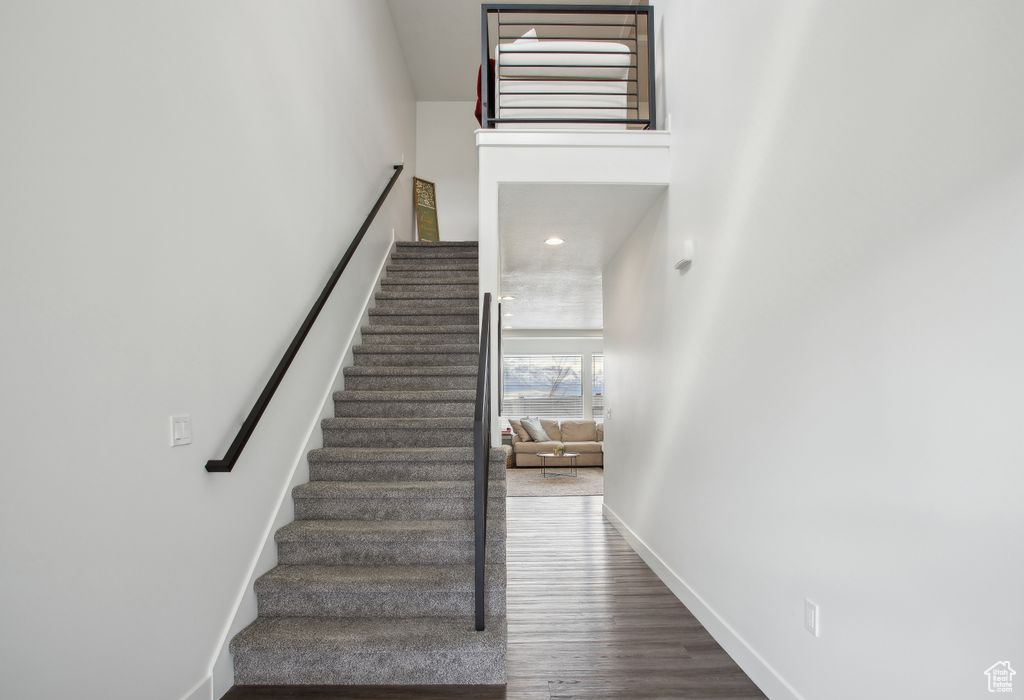 Stairway with baseboards and wood finished floors