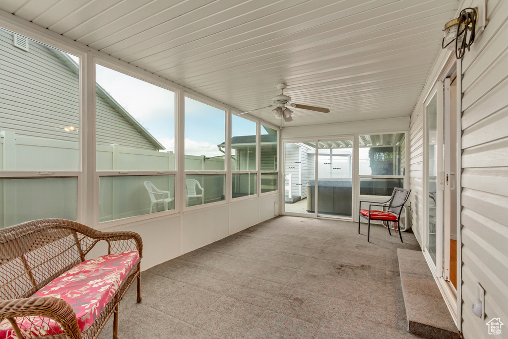 Sunroom featuring a ceiling fan