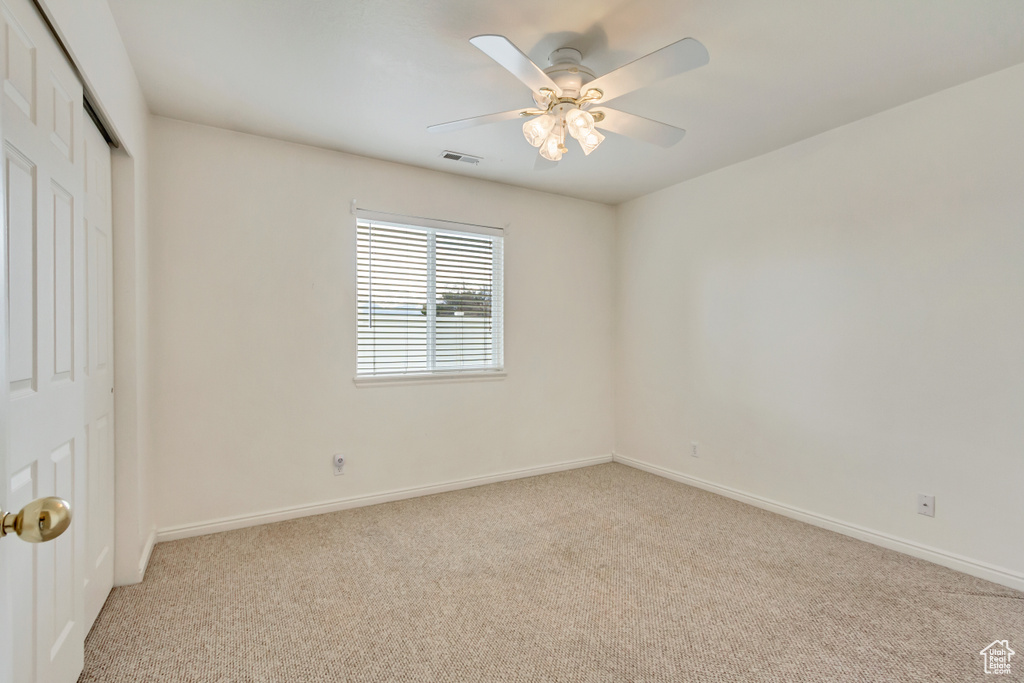 Unfurnished bedroom featuring baseboards, carpet floors, ceiling fan, visible vents, and a closet