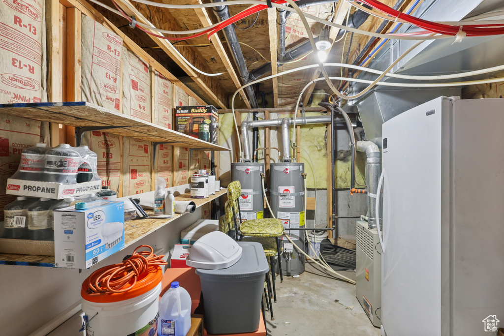 Utility room with strapped water heater and gas water heater
