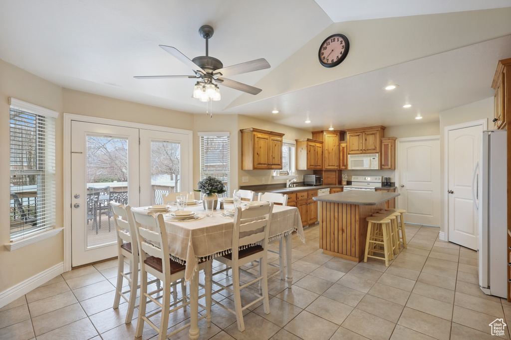 Dining room featuring light tile patterned flooring, a ceiling fan, lofted ceiling, baseboards, and recessed lighting