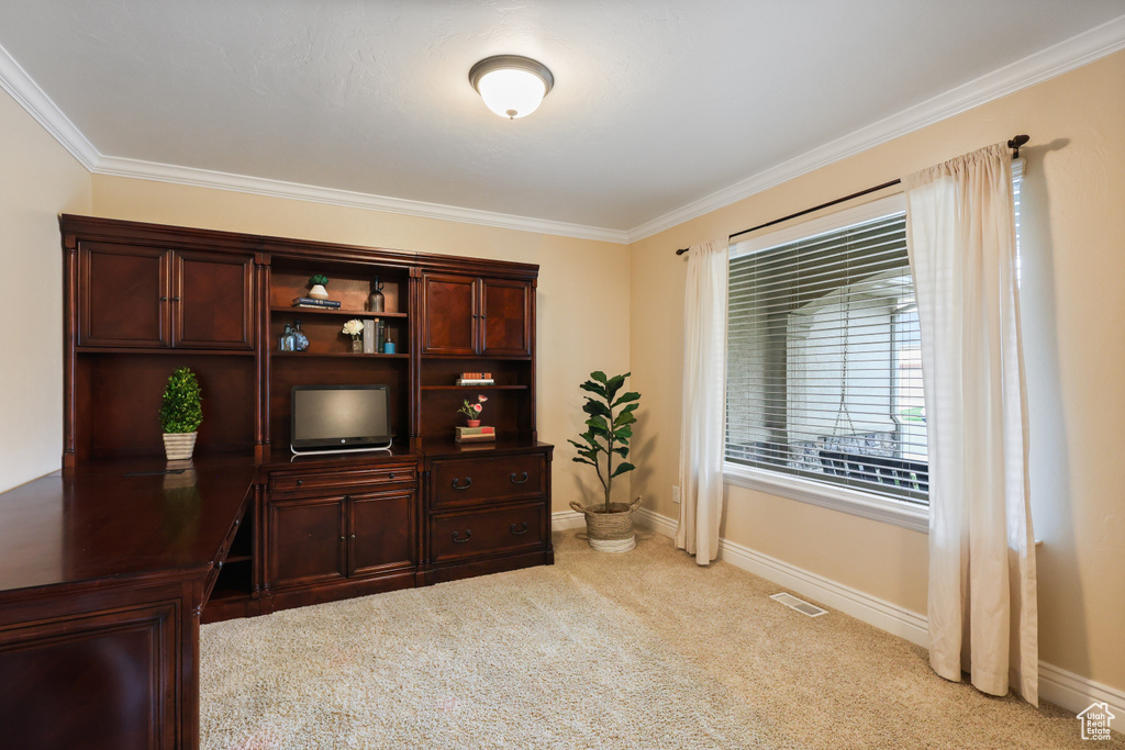 Office featuring baseboards, ornamental molding, visible vents, and light colored carpet