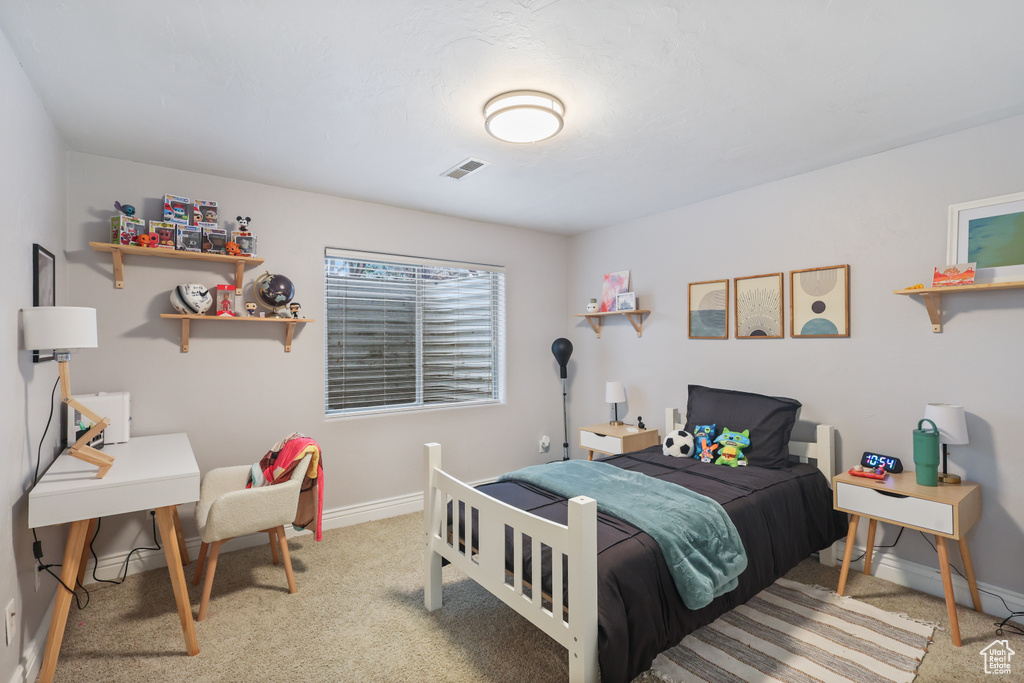 Bedroom featuring baseboards, carpet flooring, and visible vents