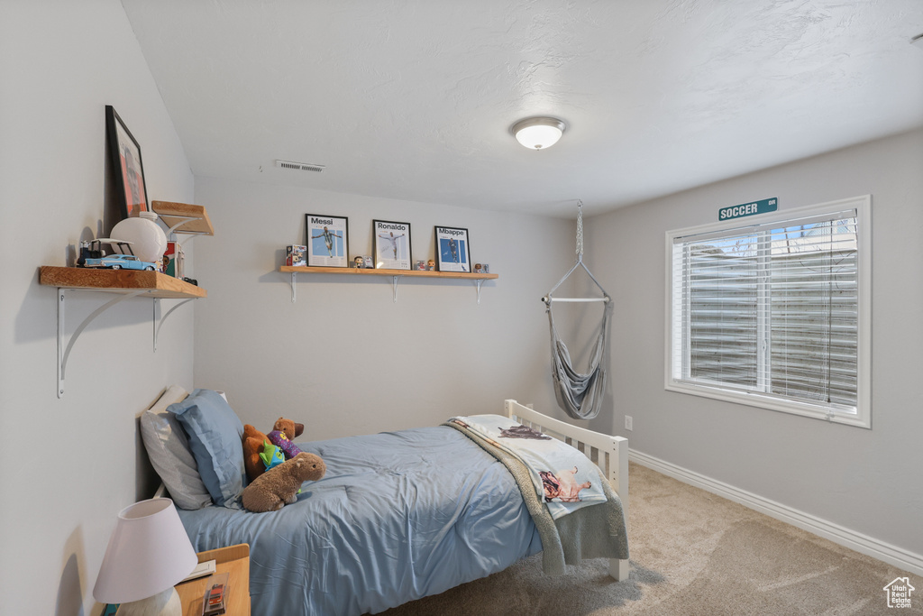 Bedroom featuring baseboards, visible vents, and carpet