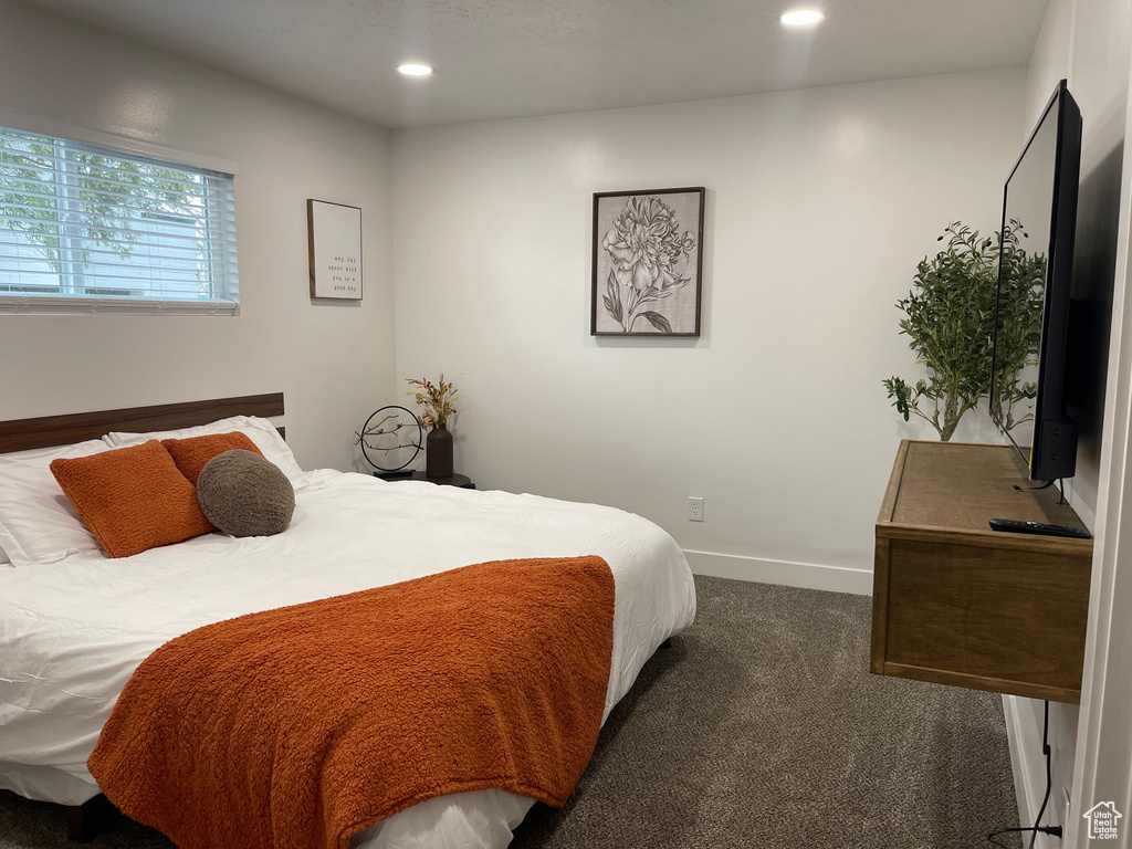 Bedroom featuring baseboards, dark carpet, and recessed lighting