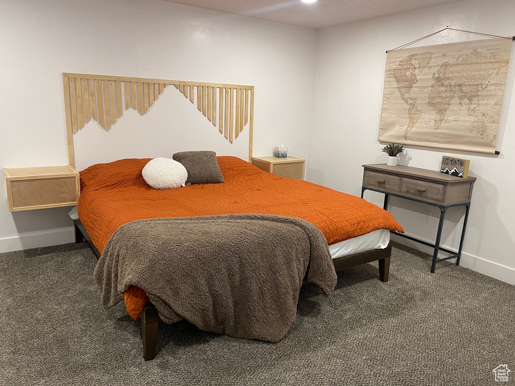 Carpeted bedroom with baseboards