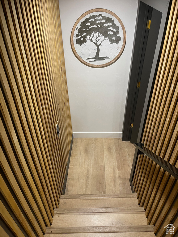Staircase featuring baseboards and hardwood / wood-style flooring