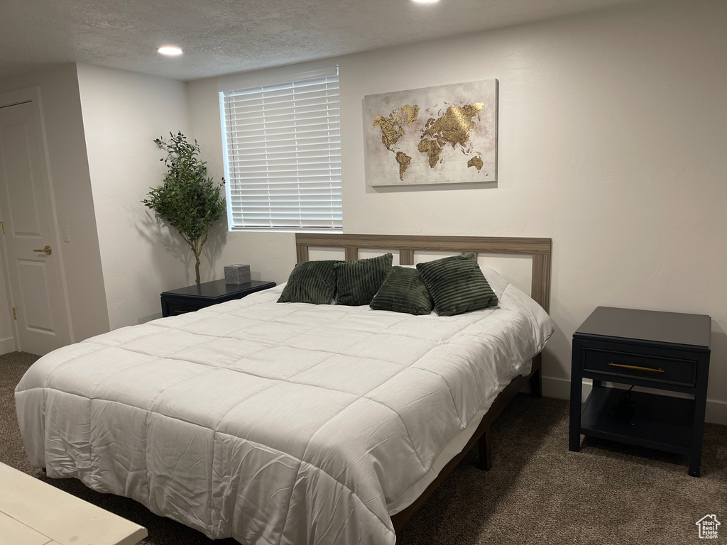 Bedroom with carpet floors, recessed lighting, and a textured ceiling