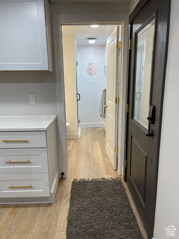 Hallway with baseboards and light wood-type flooring