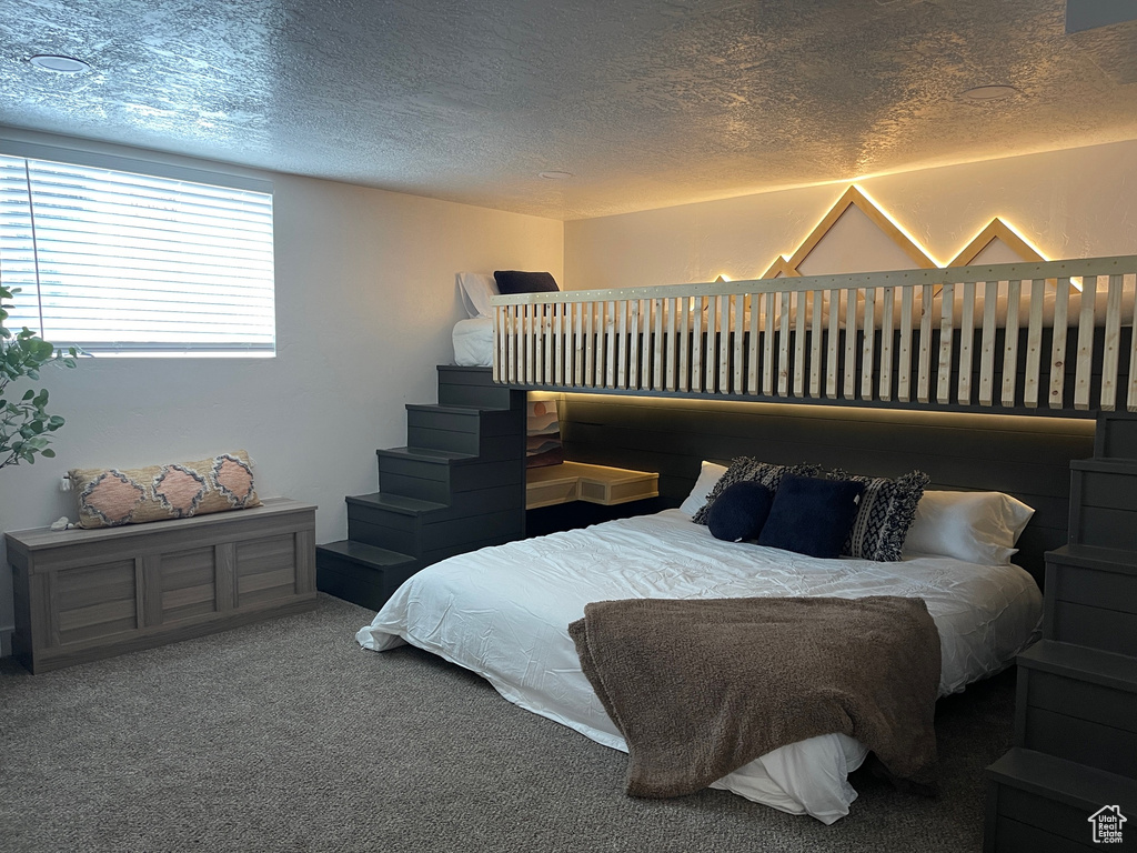 Carpeted bedroom with a textured ceiling