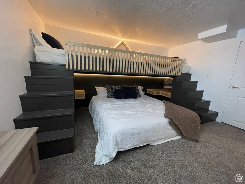 Carpeted bedroom with a textured ceiling