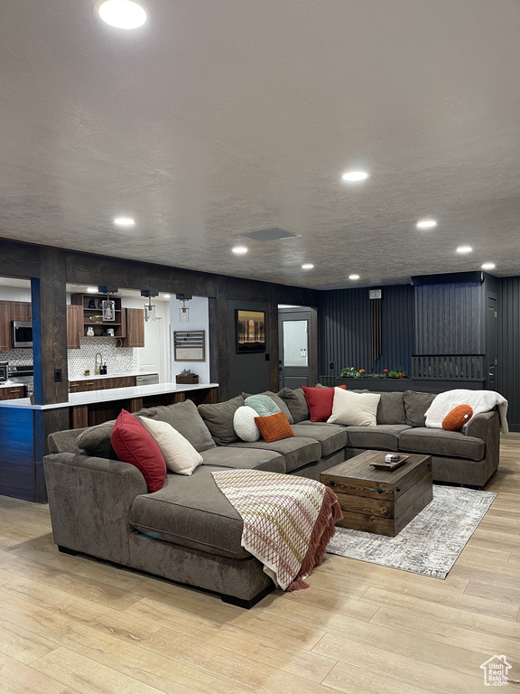 Living room featuring light wood finished floors and recessed lighting