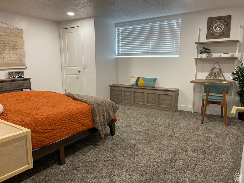 Carpeted bedroom with baseboards, recessed lighting, and a textured ceiling