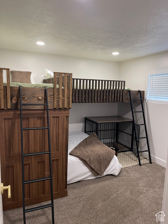 Carpeted bedroom featuring recessed lighting, baseboards, and a textured ceiling