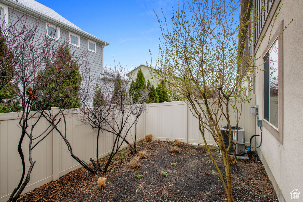 View of yard featuring cooling unit and a fenced backyard