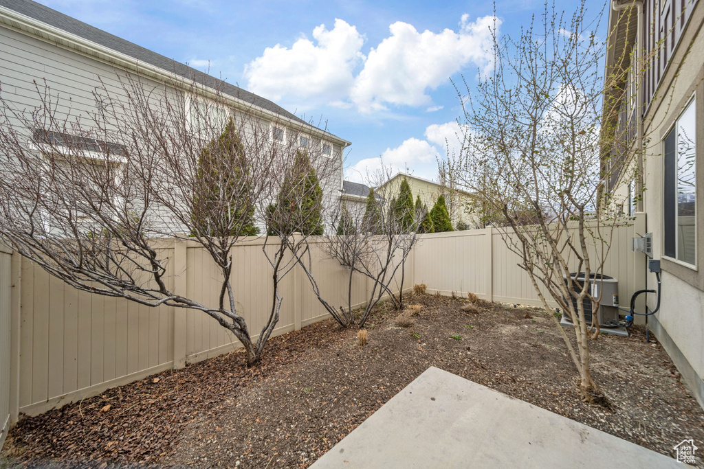 View of yard featuring cooling unit and a fenced backyard
