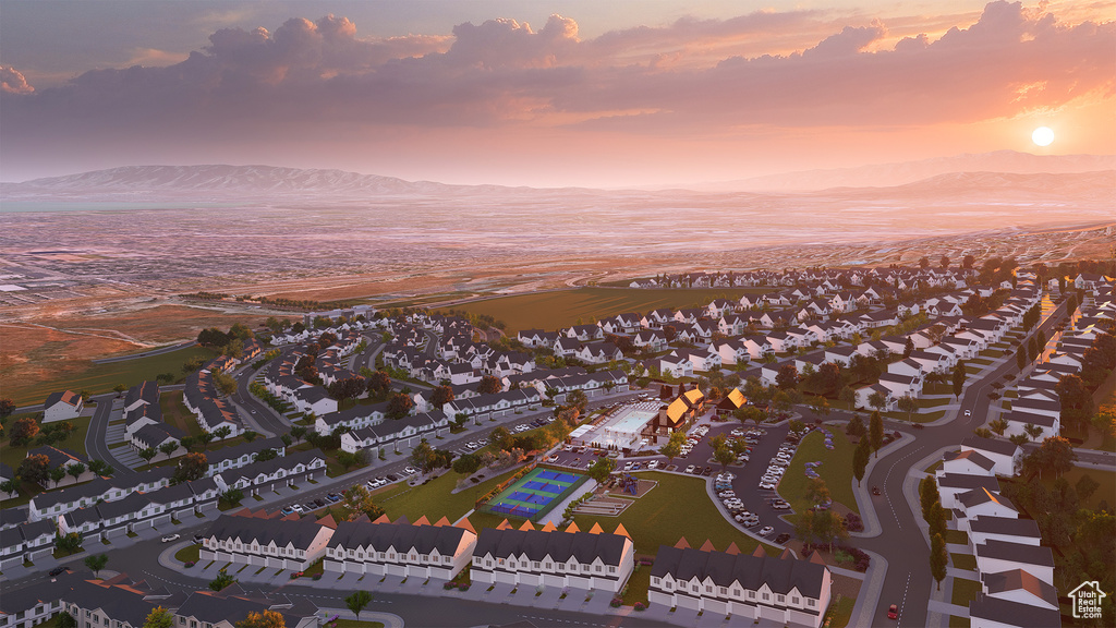 Aerial view at dusk featuring a mountain view, a beach view, and a residential view