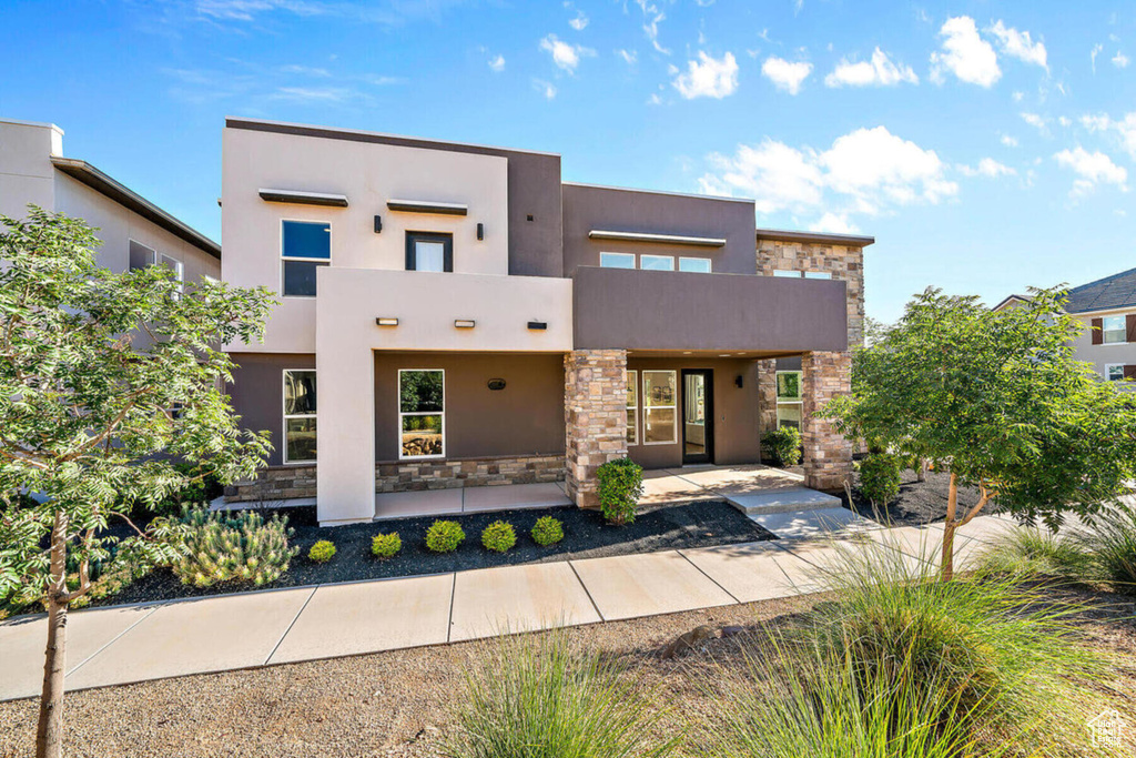 View of front facade with stucco siding and stone siding