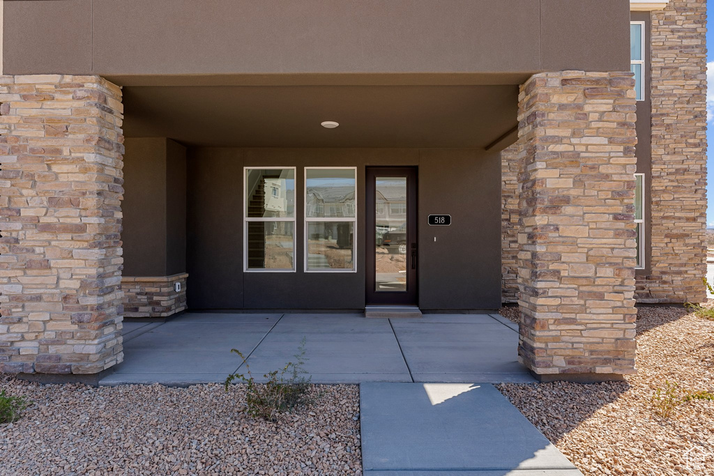 Entrance to property featuring stucco siding