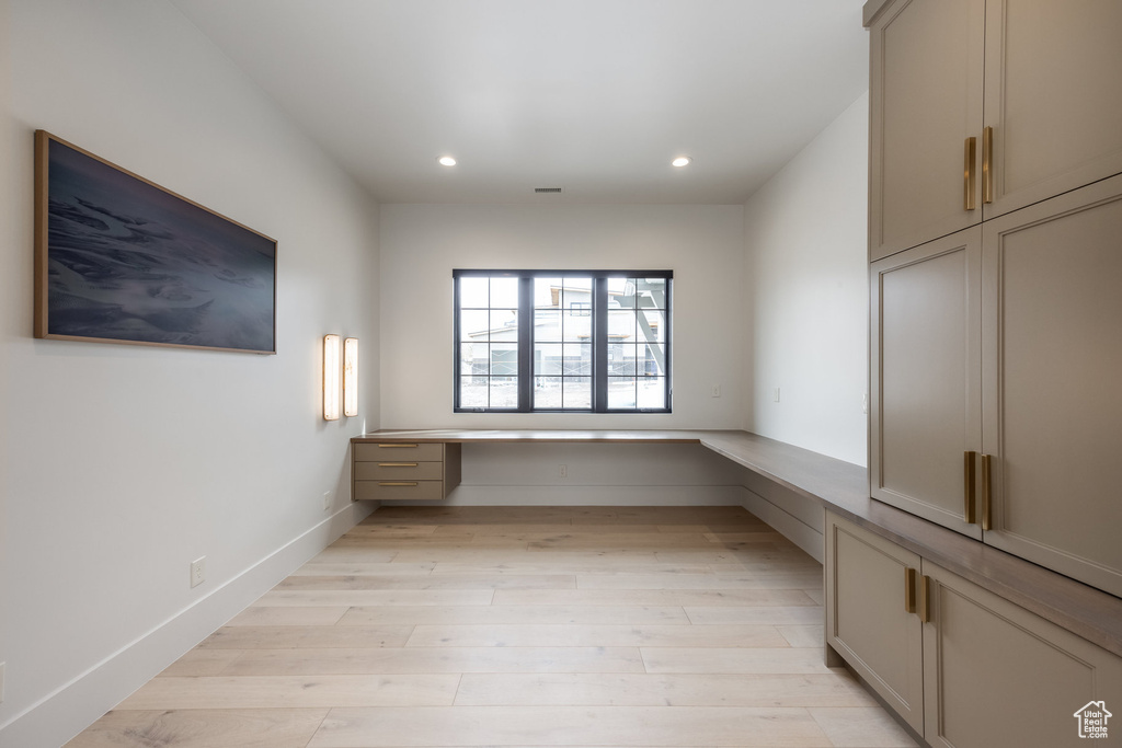 Interior space with built in study area, recessed lighting, baseboards, visible vents, and light wood-style flooring