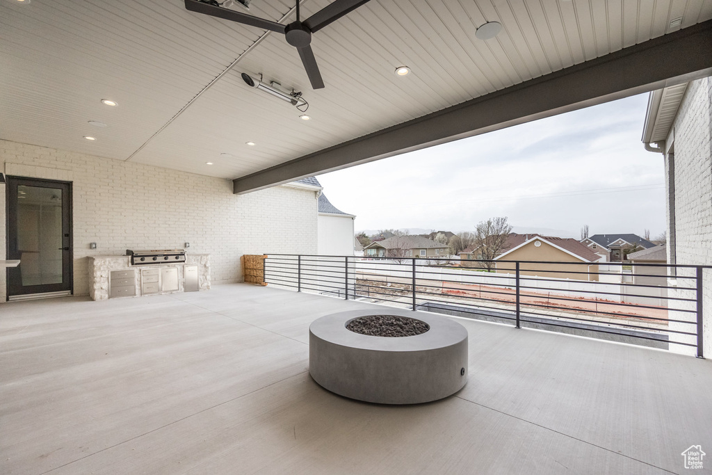 View of patio with a balcony and a grill