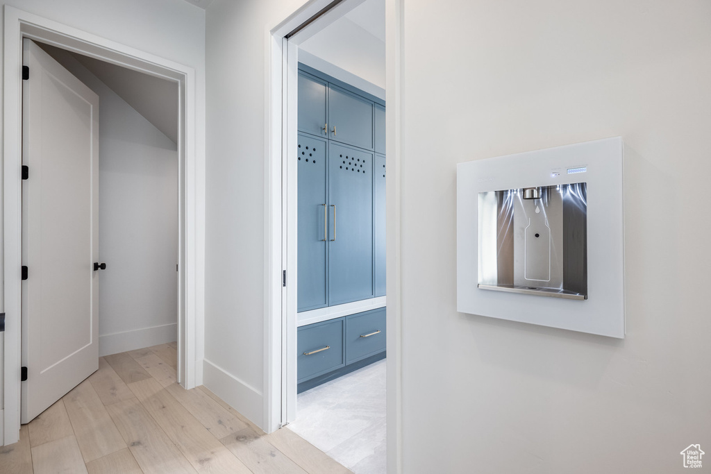 Corridor featuring baseboards and light wood-type flooring