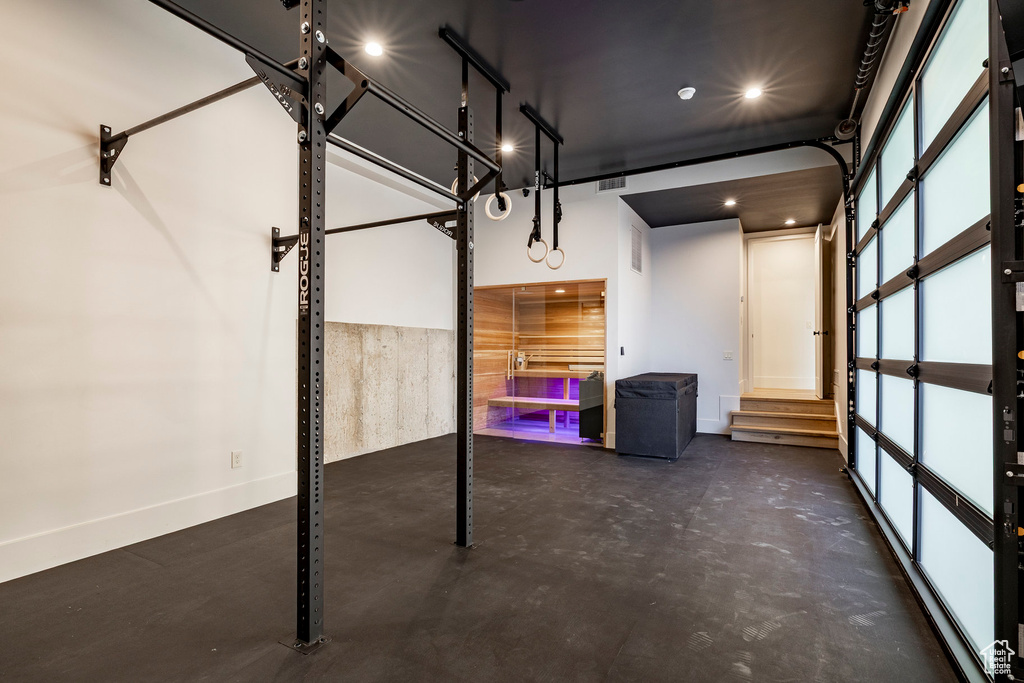 Garage featuring baseboards and recessed lighting