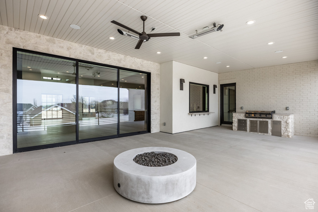 View of patio / terrace with area for grilling, ceiling fan, and an outdoor kitchen
