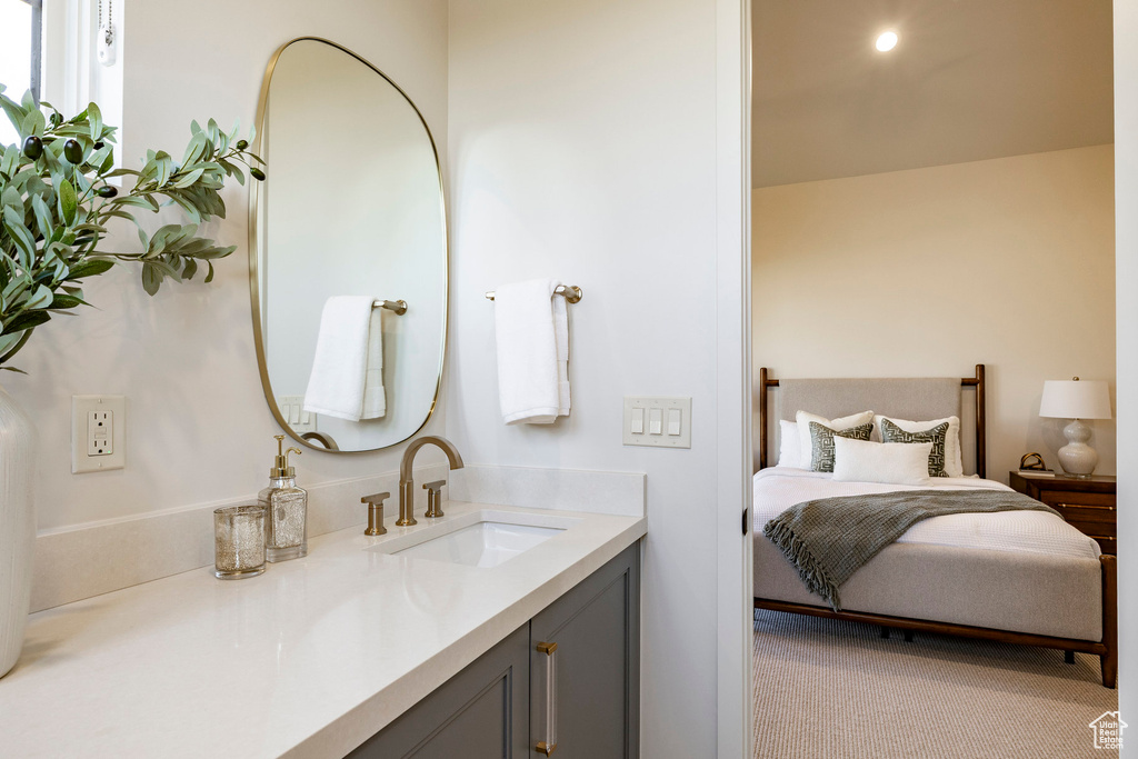 Bathroom with vanity and connected bathroom
