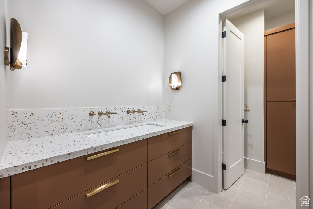 Bathroom featuring tile patterned flooring and vanity