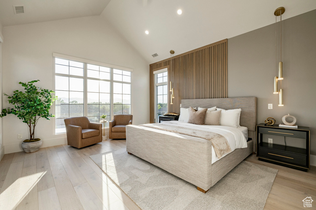 Bedroom featuring high vaulted ceiling, wood finished floors, and recessed lighting