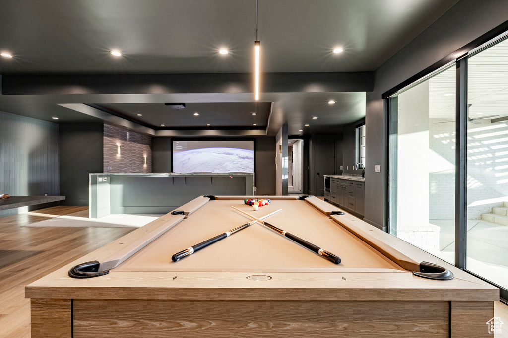 Playroom with wood finished floors, a sink, and billiards table