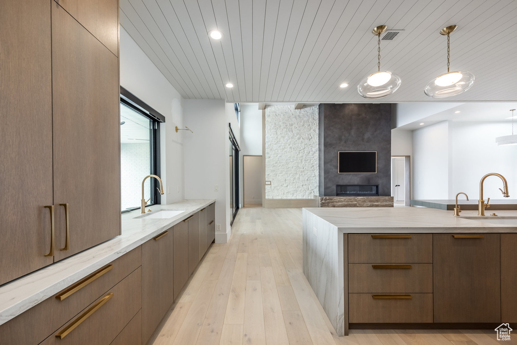 Kitchen featuring modern cabinets, a sink, and open floor plan