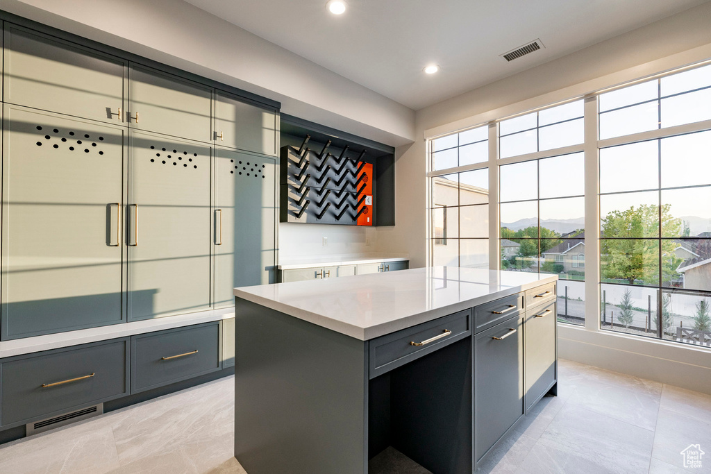 Kitchen featuring gray cabinets, light countertops, recessed lighting, a kitchen island, and a mountain view