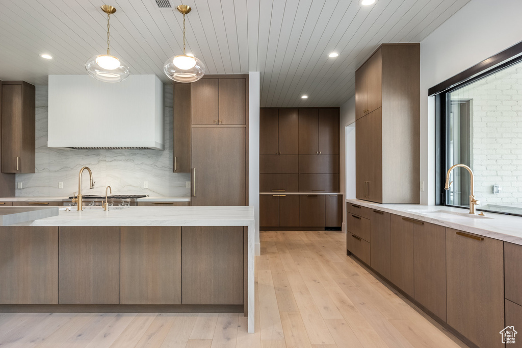 Kitchen featuring light wood-style flooring, modern cabinets, and a sink