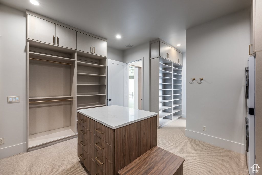 Walk in closet with light carpet