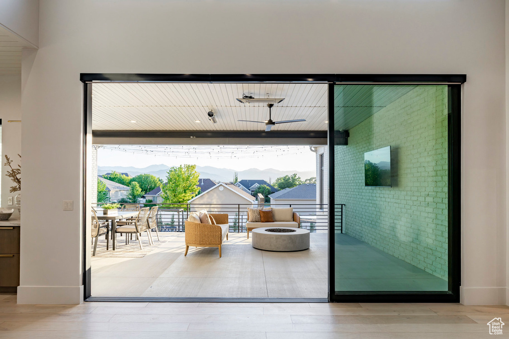 Entryway with wood finished floors, floor to ceiling windows, and baseboards