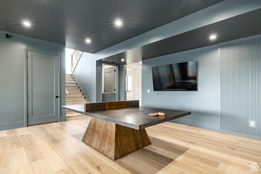 Bar with light wood-style flooring, stairway, and recessed lighting