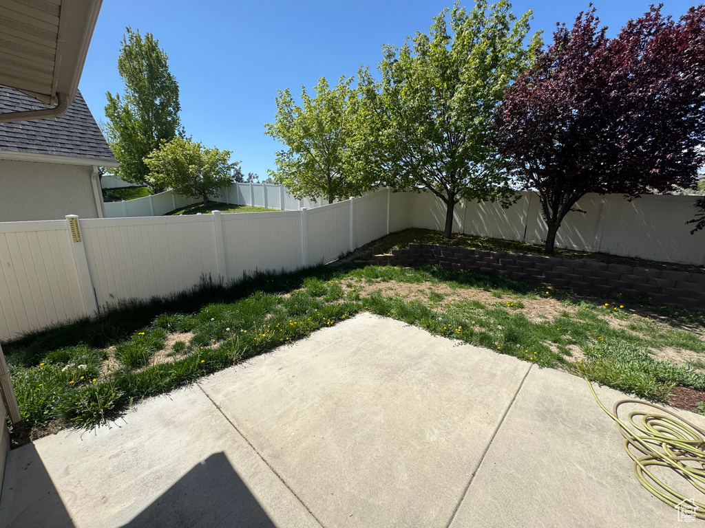 View of yard with a fenced backyard and a patio area