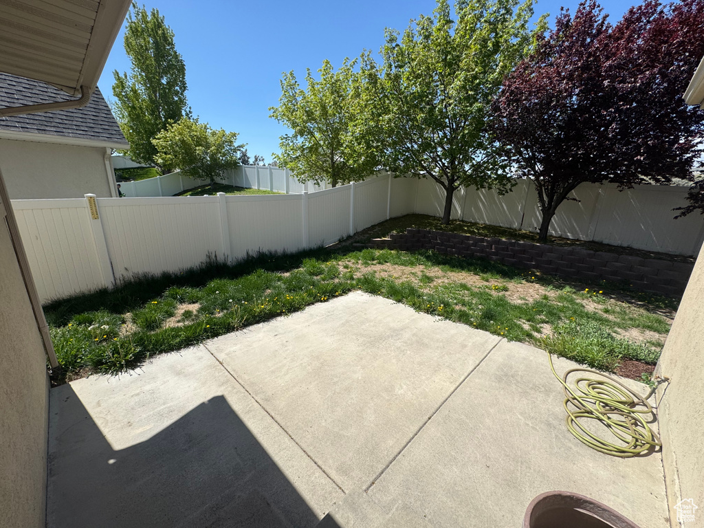 View of patio with a fenced backyard