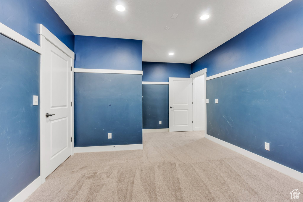 Unfurnished bedroom featuring carpet, baseboards, and recessed lighting