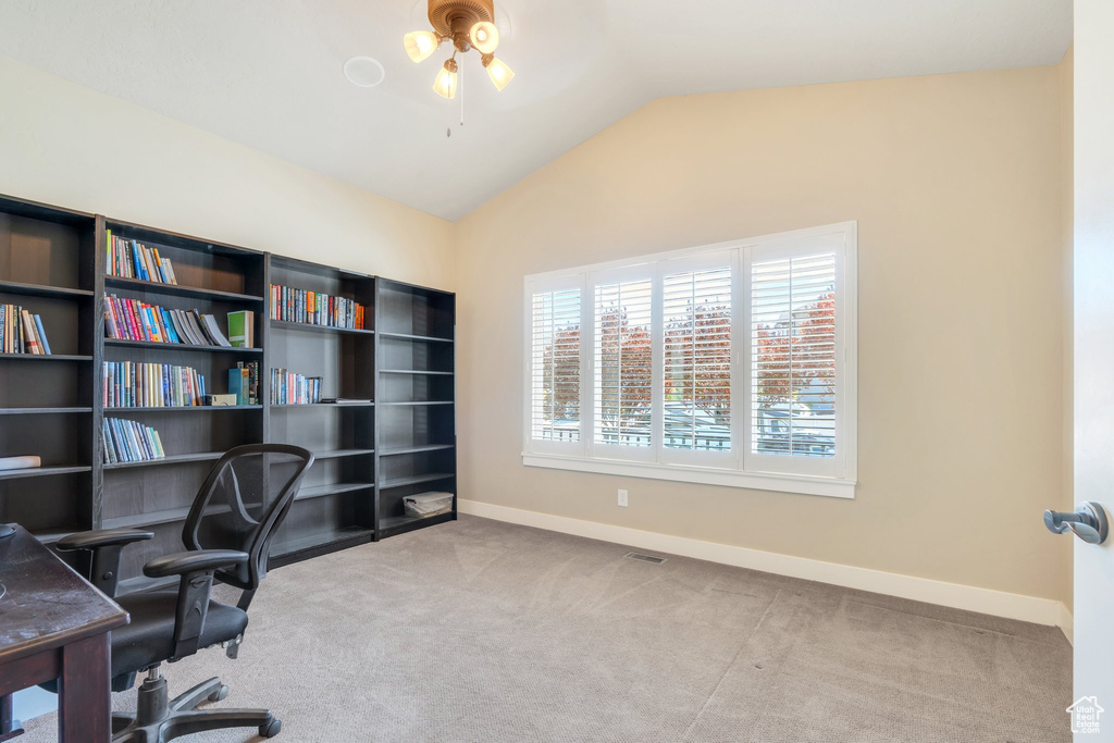 Office space with ceiling fan, lofted ceiling, baseboards, and carpet floors
