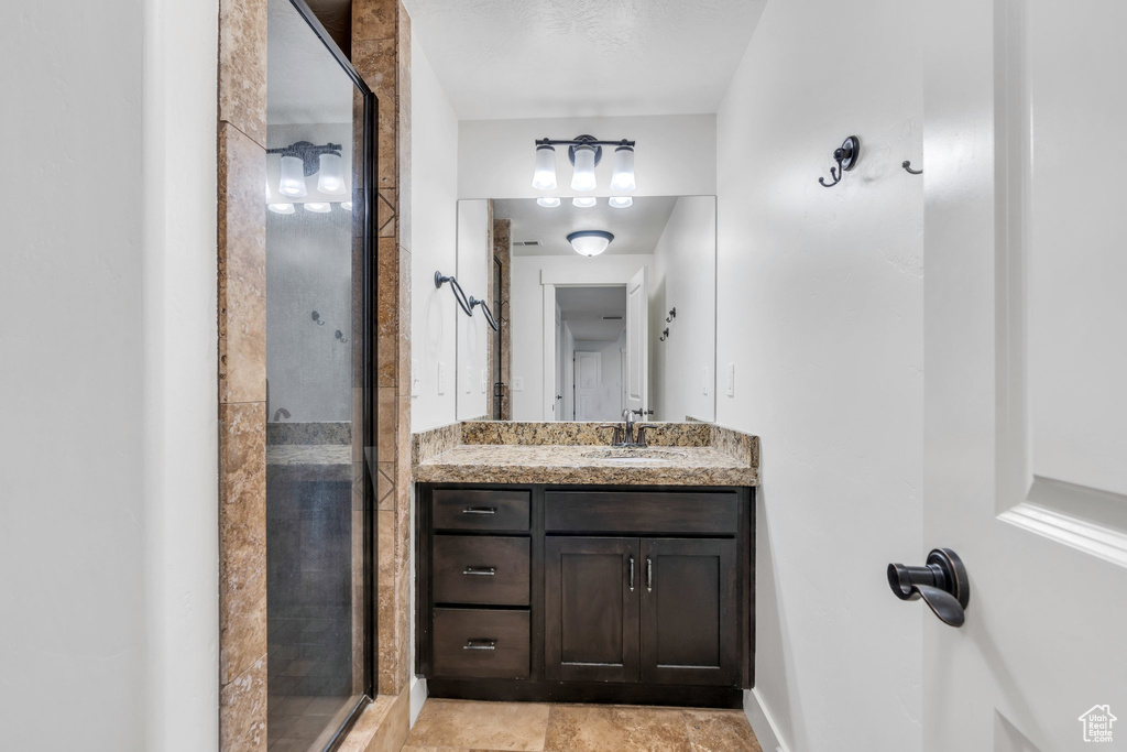 Bathroom with a shower stall and vanity