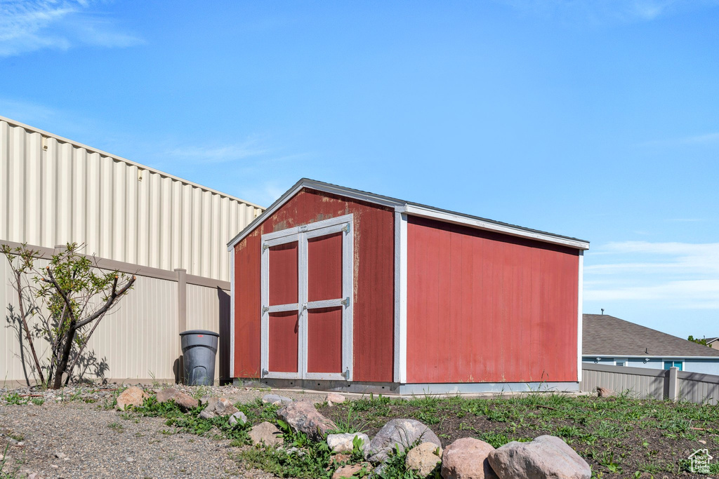 View of shed featuring fence