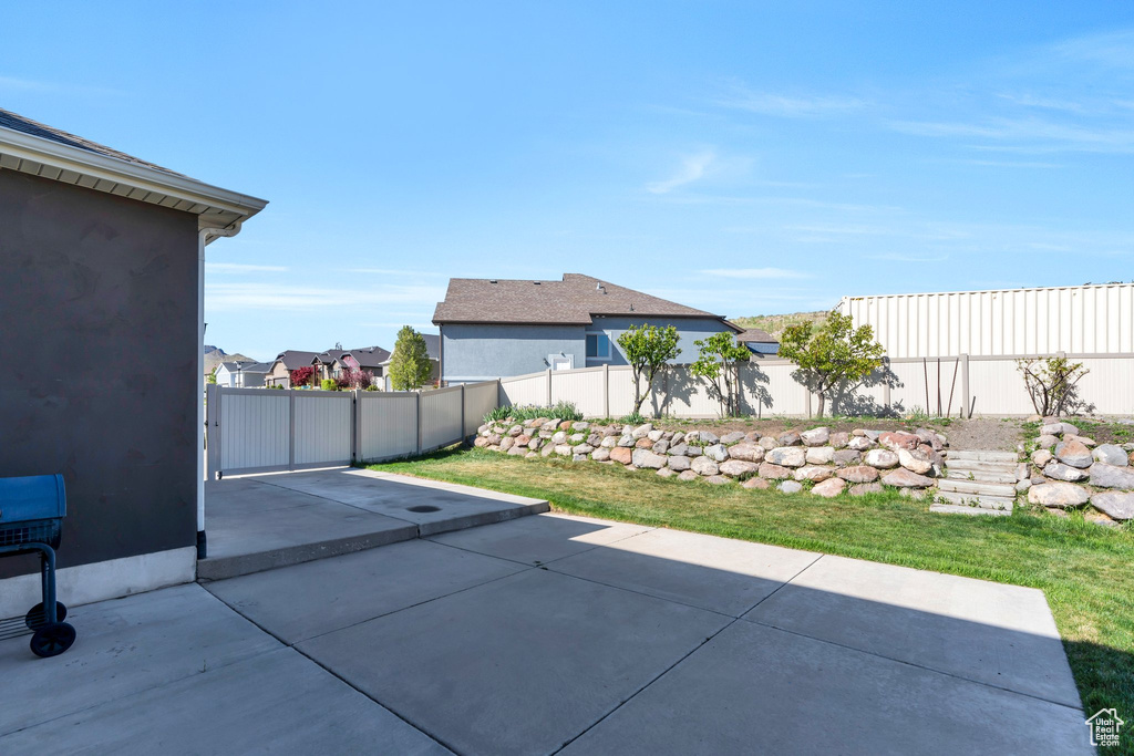 View of patio with fence and a residential view